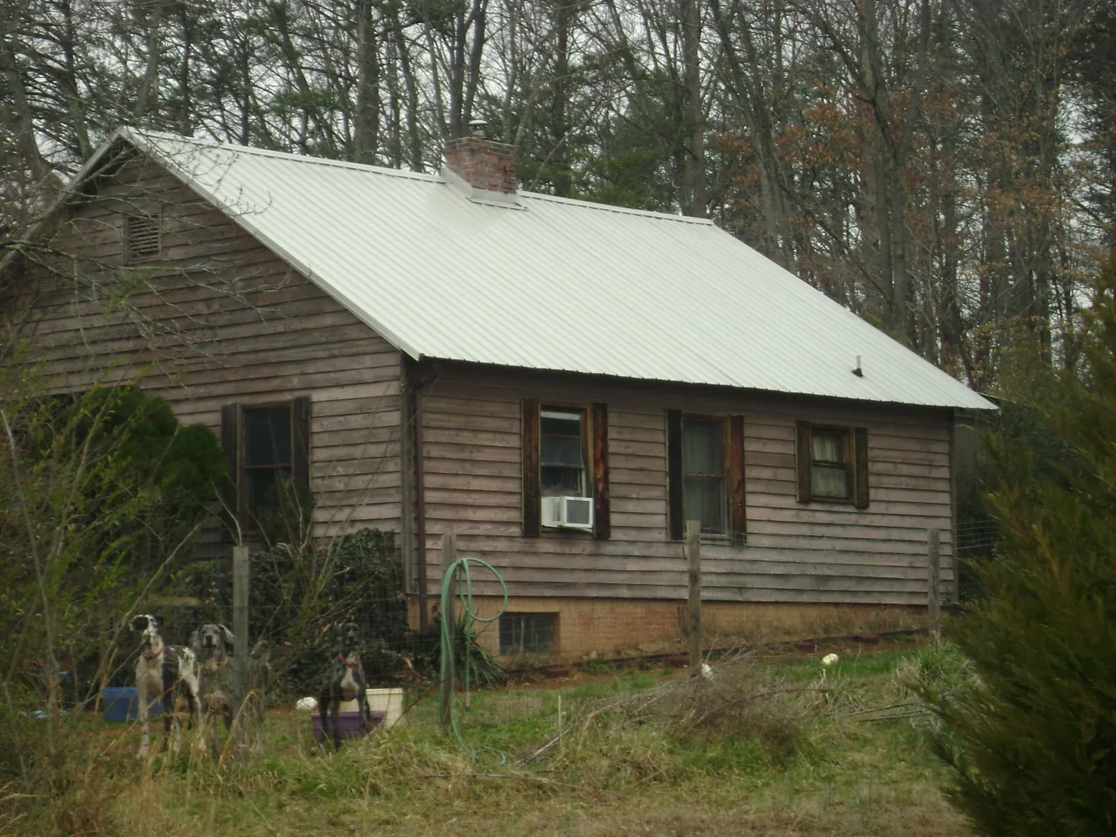 White metal roof on an old wood sided farmhouse, from a Metal Roof Installation job in Victory Mills